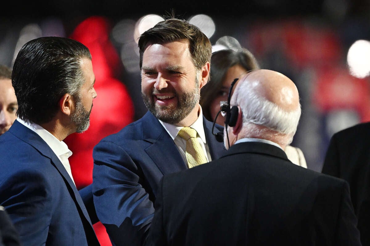 Republican vice presidential candidate, Sen. J.D. Vance speaks to Donald Trump Jr. (left) during preparations for the second day of the Republican National Convention at the Fiserv Forum on July 16, 2024, in Milwaukee, Wisconsin.