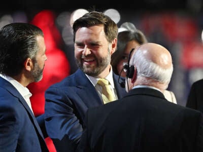Republican vice presidential candidate, Sen. J.D. Vance speaks to Donald Trump Jr. (left) during preparations for the second day of the Republican National Convention at the Fiserv Forum on July 16, 2024, in Milwaukee, Wisconsin.