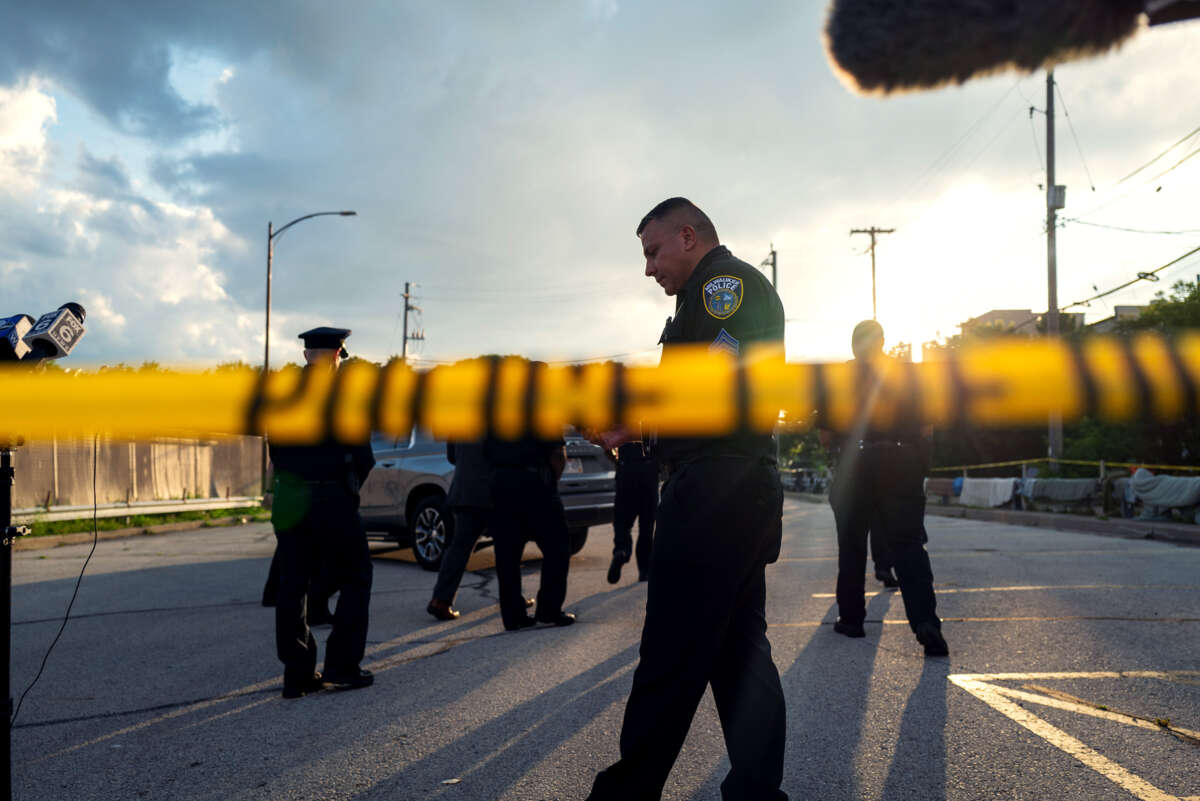 Cops mill around behind police tape