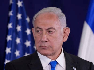 Israeli Prime Minister Benjamin Netanyahu looks on as the U.S. Secretary of State gives statements to the media inside The Kirya, which houses the Israeli Defence Ministry, after their meeting in Tel Aviv on October 12, 2023.