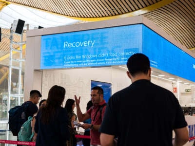 Passengers at Madrid-Barajas Airport gather during the crash of Microsoft's security system, which has caused failures at major companies around the world, on July 19, 2024, in Madrid, Spain.