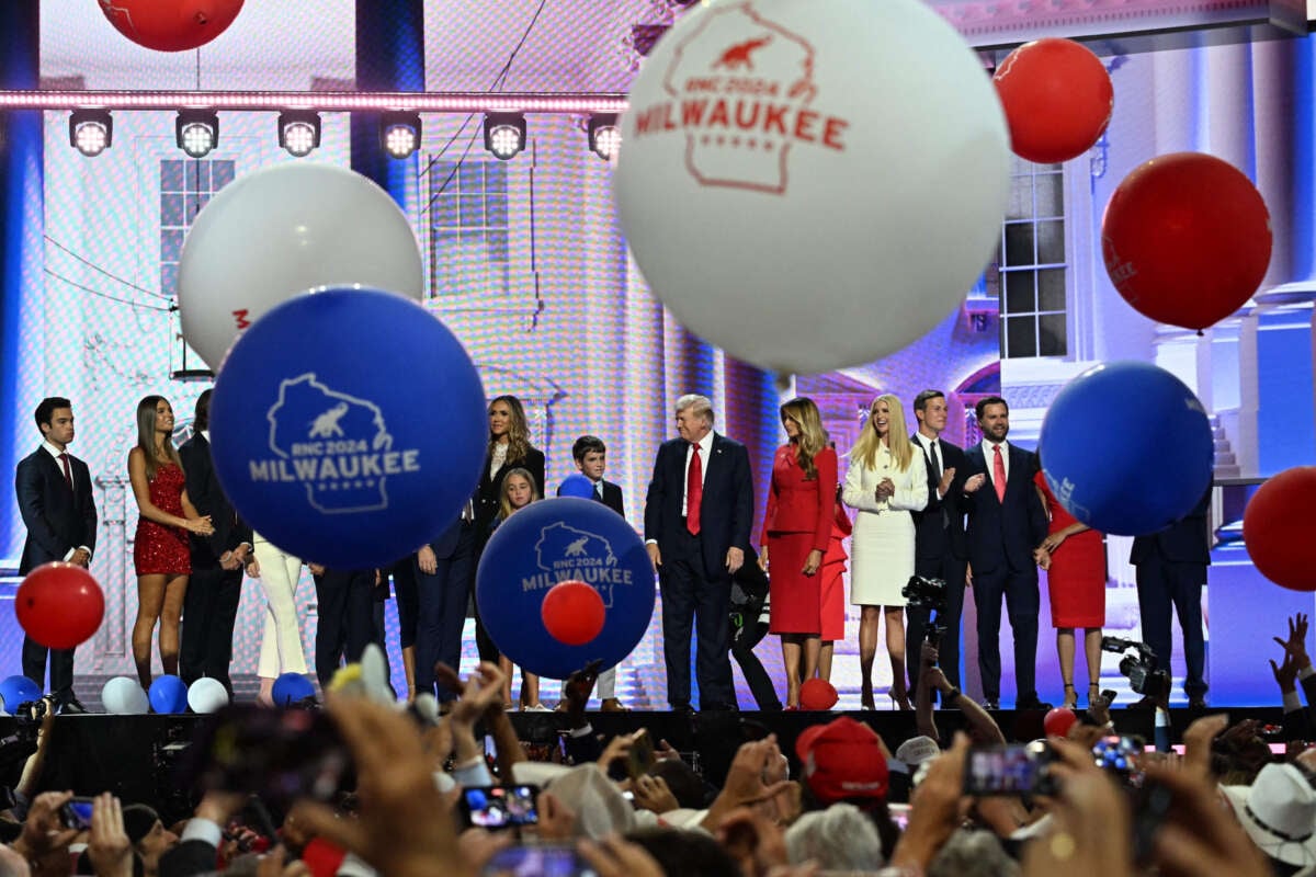Former President Donald Trump (center) stands onstage alongside his family, former First Lady Melania Trump, Senator from Ohio and 2024 Republican vice presidential candidate J.D. Vance (3rd right) and his wife, lawyer Usha Vance, during the last day of the 2024 Republican National Convention at the Fiserv Forum in Milwaukee, Wisconsin, on July 18, 2024.