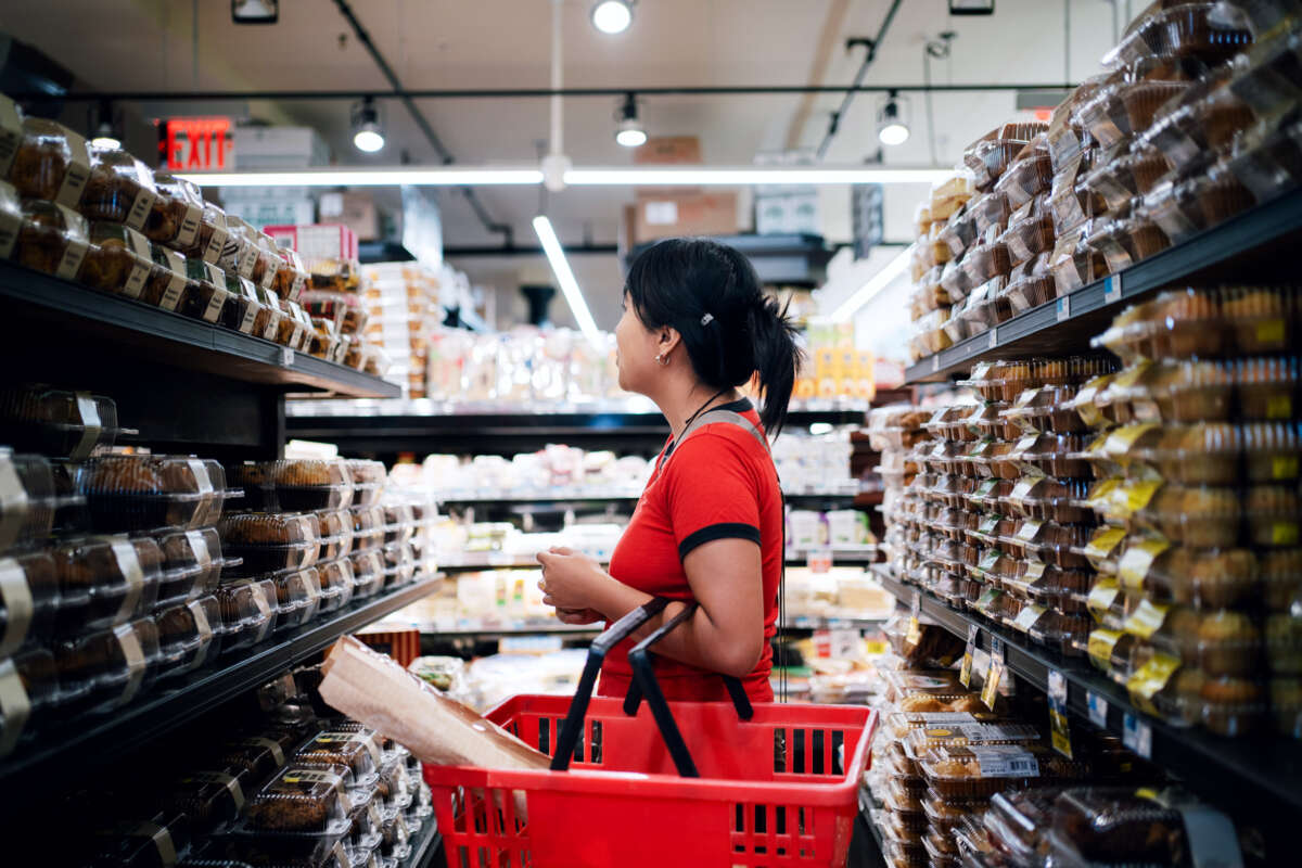 A woman shops in the pastry aisle of a grocery store