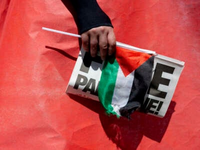Pro-Palestine demonstrators hold up a red banner, representing a red line, near the White House in protest against the treatment of Palestinians by Israel, on June 8, 2024, in Washington, D.C.