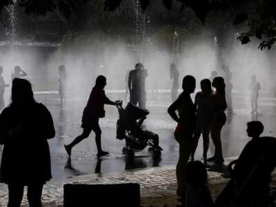 People cool off at a fountain in the Madrid Río Park amid heat wave conditions in Madrid on July 23, 2024. The Copernicus Climate Change Service (C3S) said the global average surface air temperature on July 21 was 17.09 degrees Celsius, a fraction above the previous record set in 2023.