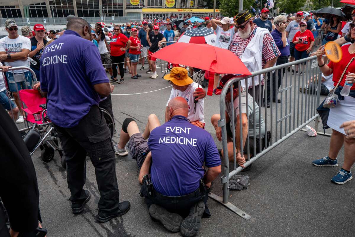 Event medics respond to a heat-related call after a person passed out while waiting in line ahead of Republican Presidential nominee former President Donald Trump's campaign rally at the Bojangles Coliseum on July 24, 2024, in Charlotte, North Carolina.