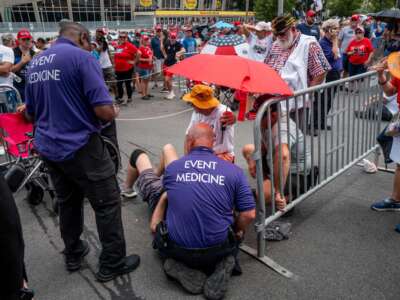 Event medics respond to a heat-related call after a person passed out while waiting in line ahead of Republican Presidential nominee former President Donald Trump's campaign rally at the Bojangles Coliseum on July 24, 2024, in Charlotte, North Carolina.