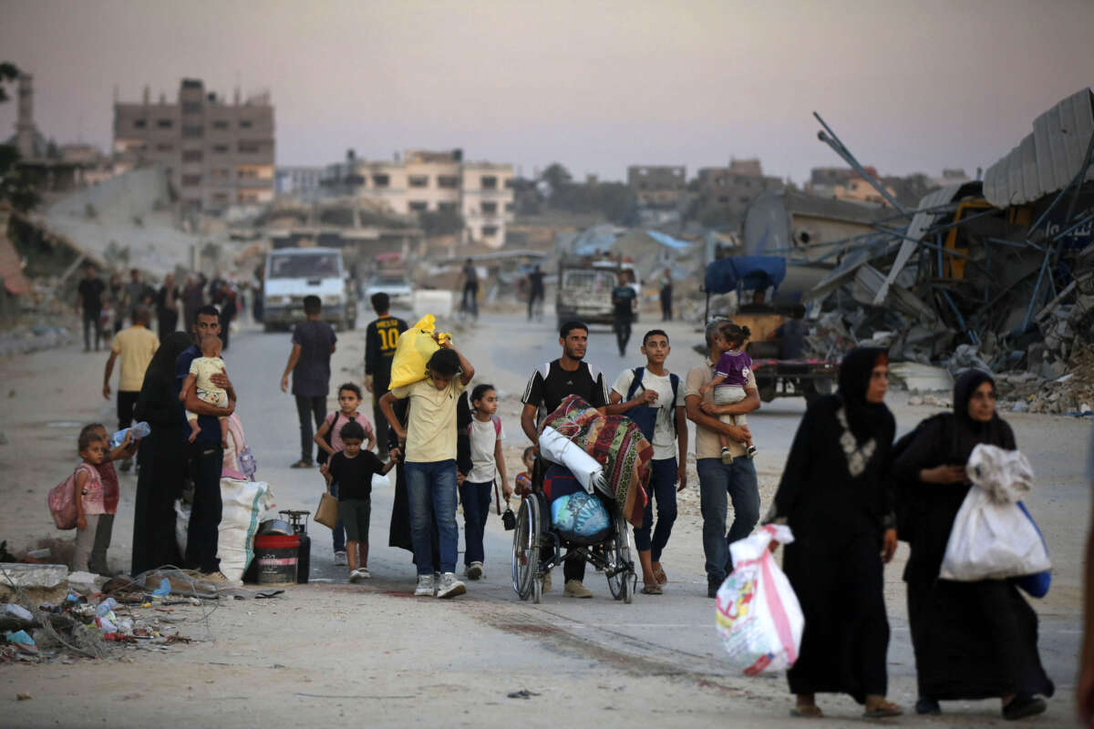 Palestinians, including children, evacuate the area with their belongings after the Israeli army announced an operation to be organized at the Bureij refugee camp in Deir al-Balah, Gaza, on July 28, 2024.