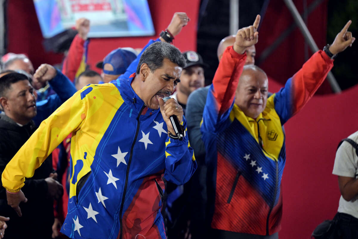 Nikolas Maduro delivers a speech into a microphone