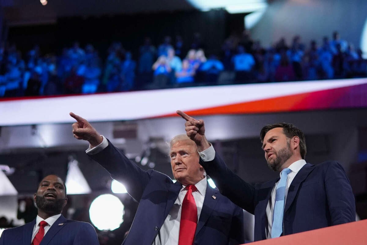 Republican presidential candidate, former President Donald Trump (center) and Republican vice presidential candidate, Sen. J.D. Vance, appear on the first day of the Republican National Convention at the Fiserv Forum on July 15, 2024, in Milwaukee, Wisconsin.