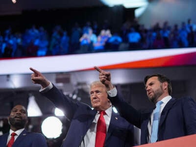 Republican presidential candidate, former President Donald Trump (center) and Republican vice presidential candidate, Sen. J.D. Vance, appear on the first day of the Republican National Convention at the Fiserv Forum on July 15, 2024, in Milwaukee, Wisconsin.