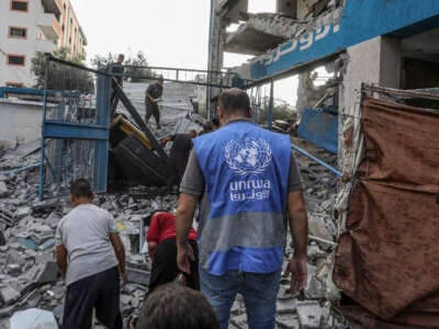 Palestinians and UN workers examine the destroyed makeshift tents and shelters after Israeli attack hits a United Nations Relief and Works Agency for Palestine Refugees in the Near East (UNRWA) school, killing and injuring many in Nuseirat Refugee Camp of Deir al-Balah, Gaza, on July 15, 2024.