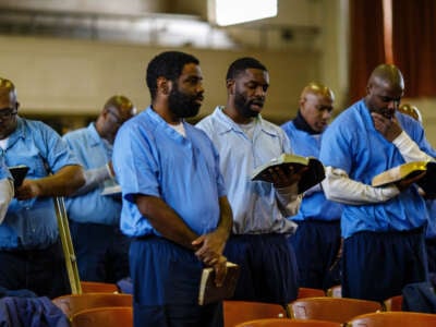 Inmates sing as Helen Sinclair, a 98-year-old volunteer prison chaplain known as Queen Mother, helps lead in a church service on February 10, 2019, at the Stateville Correctional Center in Illinois.