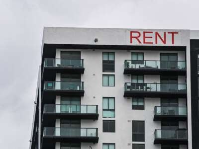 A "Rent" sign is displayed on an apartment building in Miami, Florida, on January 20, 2022. The increase in real estate prices in South Florida is one of the highest in the U.S.