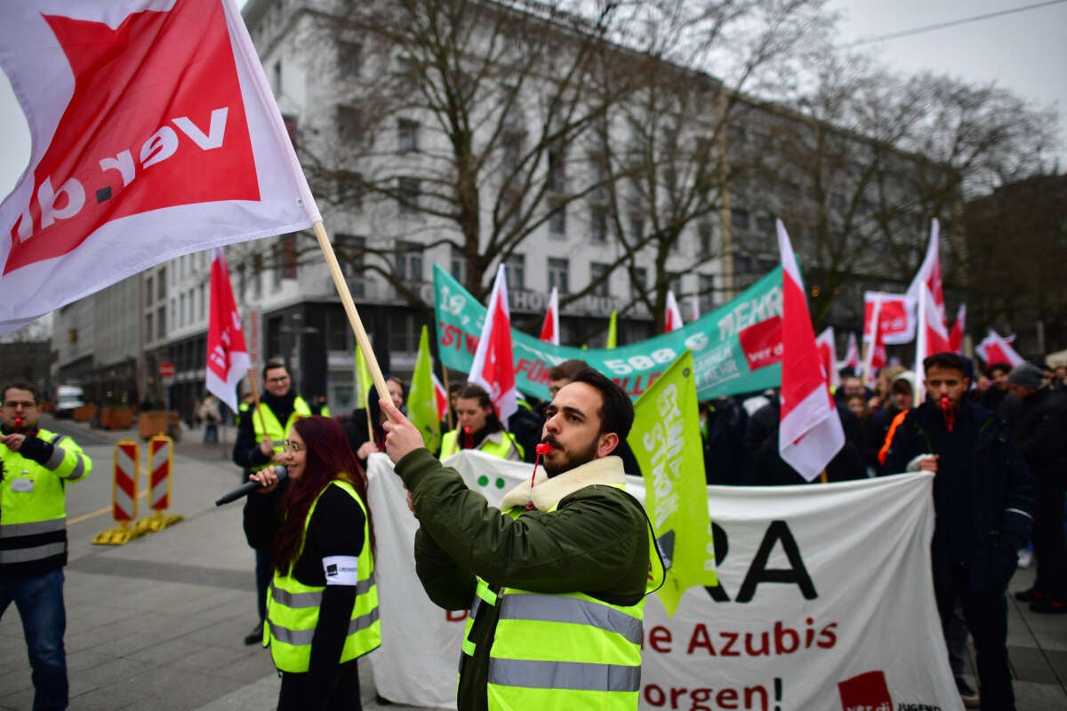 Striking public transport workers and activists from the Fridays For Future climate movement walk with flags during a protest on March 3, 2023 in Hanover, Germany.