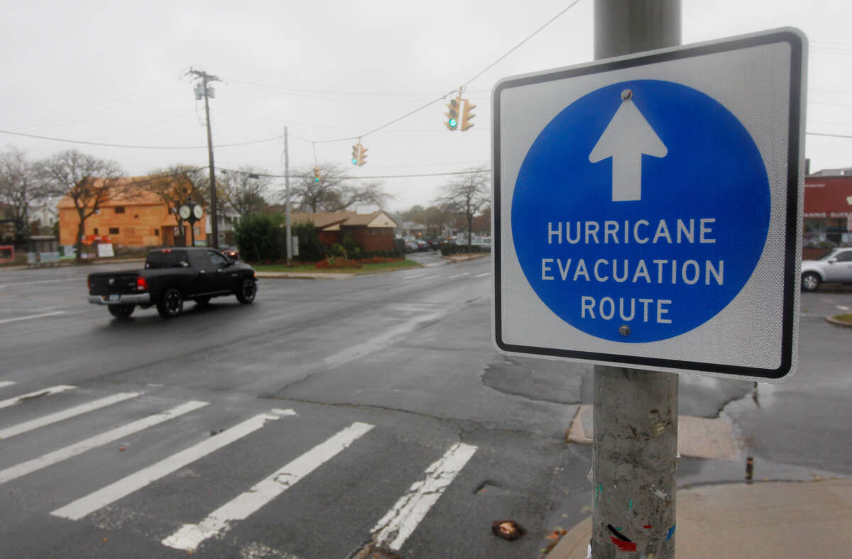 A hurricane evacuation route sign hangs on a post on October 28, 2012, in Long Beach, New York.