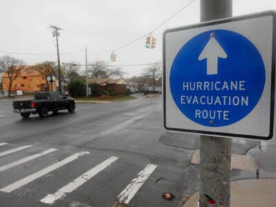 A hurricane evacuation route sign hangs on a post on October 28, 2012, in Long Beach, New York.