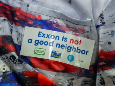 A Baytown resident wears a sticker that reads Exxon is not a good neighbor as residents spoke during formal public comments about the Exxon Mobil Corporations Baytown Olefins Plant on February 5, 2024, in Baytown, Texas.