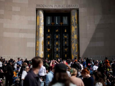 People gather to watch the partial solar eclipse from Brooklyn Public Library on April 8, 2024, in Brooklyn, New York.