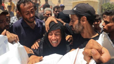 A Palestinian woman reacts over the corpse of a family member in front of the morgue of the Nasser hospital in Khan Yunis, Gaza, on July 13, 2024, one of the health establishments to which casualties were rushed after an Israeli strike killed at least 90 people at the Al-Mawasi camp.