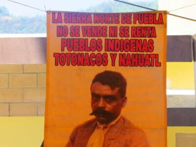This banner, displayed at a community meeting in the Sierra Norte, says, "The Sierra Norte of Puebla can't be sold nor rented out – Nahua and Totonaco Indigenous Peoples."
