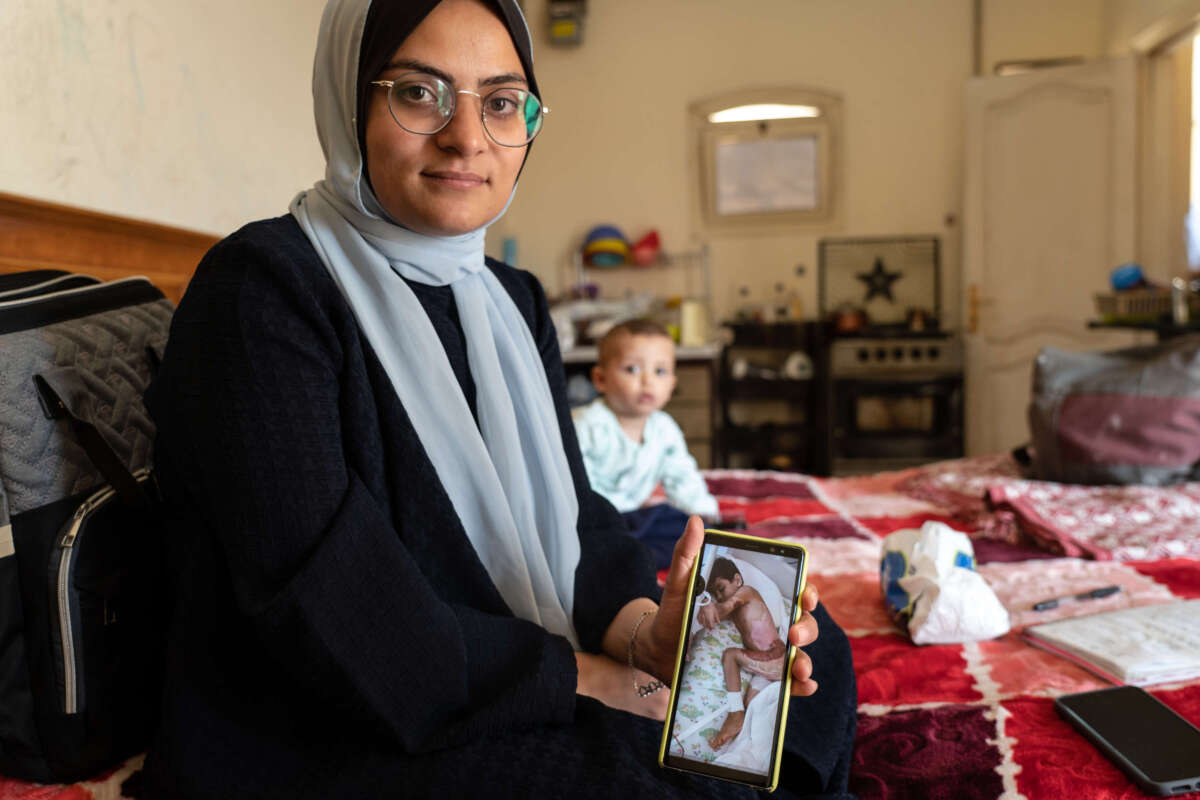 Hashim shows a photo on her mobile phone of her nephew who was injured in an airstrike in the north of Gaza.