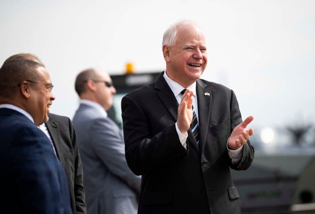 Minnesota Governor Tim Walz (center) awaits the arrival of Vice President Kamala Harris at the Minneapolis-St. Paul International Airport in Saint Paul, Minnesota, on March 14, 2024.