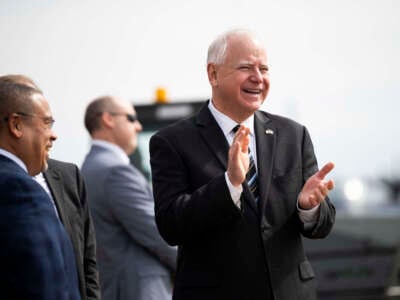 Minnesota Governor Tim Walz (center) awaits the arrival of Vice President Kamala Harris at the Minneapolis-St. Paul International Airport in Saint Paul, Minnesota, on March 14, 2024.