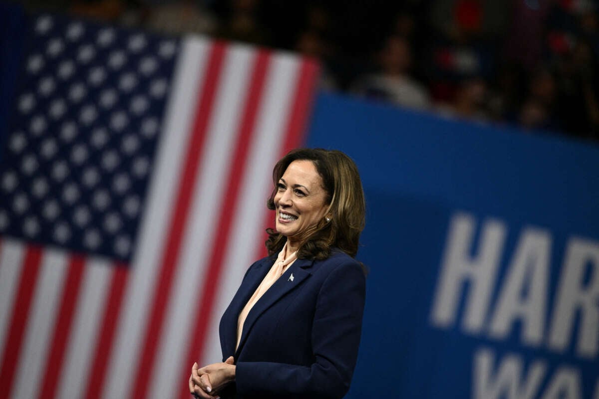 Vice President and 2024 Democratic presidential candidate Kamala Harris reacts as her running mate Minnesota Governor Tim Walz speaks at Temple University's Liacouras Center in Philadelphia, Pennsylvania, on August 6, 2024.