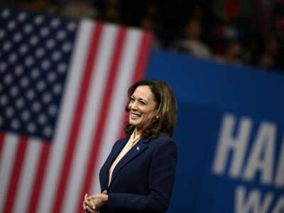 Vice President and 2024 Democratic presidential candidate Kamala Harris reacts as her running mate Minnesota Governor Tim Walz speaks at Temple University's Liacouras Center in Philadelphia, Pennsylvania, on August 6, 2024.