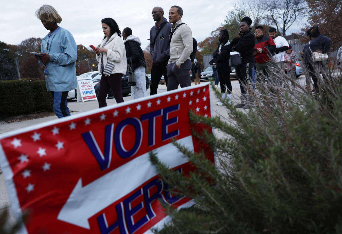 Residents wait in line to vote early outside a polling station on November 29, 2022, in Atlanta, Georgia.