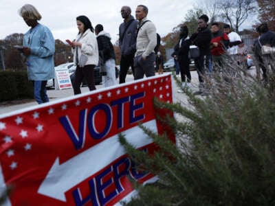 Residents wait in line to vote early outside a polling station on November 29, 2022, in Atlanta, Georgia.