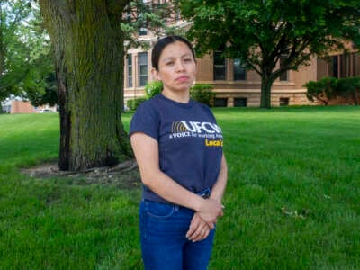 Dina Velasquez Escalante, a meat packer and union steward, poses for a portrait in St. James, Minnesota, while repping her union, UFCW Local 663.