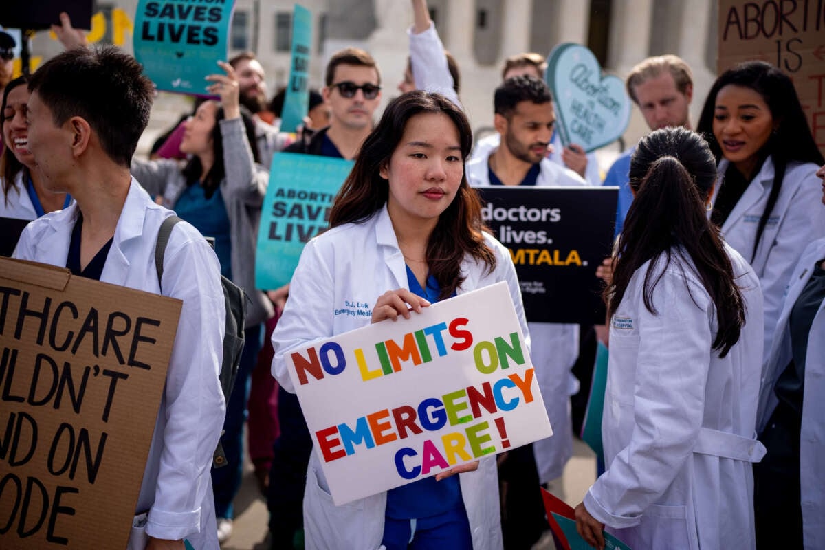 A group of doctors join abortion rights supporters at a rally outside the Supreme Court on April 24, 2024, in Washington, D.C.