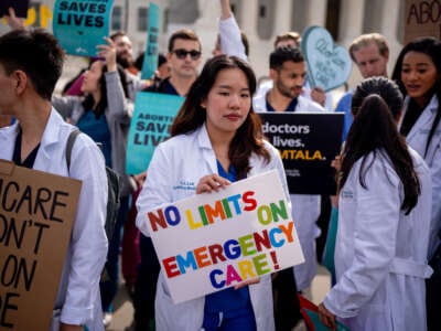 A group of doctors join abortion rights supporters at a rally outside the Supreme Court on April 24, 2024, in Washington, D.C.