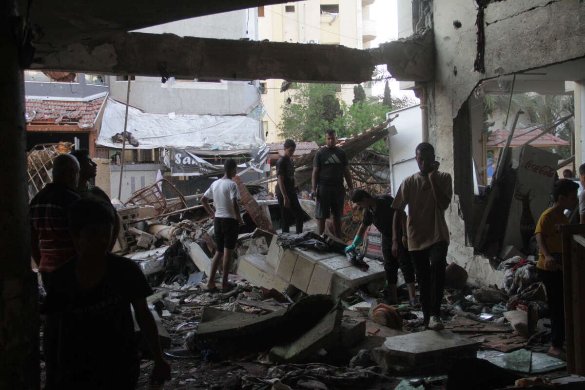 People conduct rescue work in a destroyed building after an Israeli airstrike in Al-Daraj neighborhood in Gaza City, August 10, 2024.