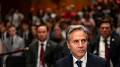 Pro-Palestine demonstrators hold painted hands as U.S. Secretary of State Antony Blinken arrives for a Senate Foreign Relations Committee hearing on Capitol Hill on May 21, 2024, in Washington, D.C.