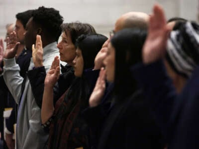 New U.S. citizens take the oath during a naturalization ceremony at the National Archives on December 15, 2023, in Washington, D.C.