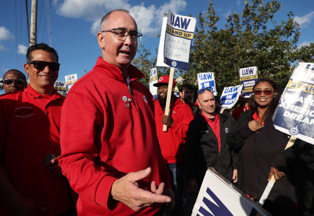 United Auto Workers President Shawn Fain, middle, visits striking UAW Local 551 workers outside a Ford assembly center on South Burley Avenue on October 7, 2023, in Chicago, Illinois.