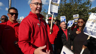 United Auto Workers President Shawn Fain, middle, visits striking UAW Local 551 workers outside a Ford assembly center on South Burley Avenue on October 7, 2023, in Chicago, Illinois.