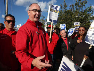 United Auto Workers President Shawn Fain, middle, visits striking UAW Local 551 workers outside a Ford assembly center on South Burley Avenue on October 7, 2023, in Chicago, Illinois.