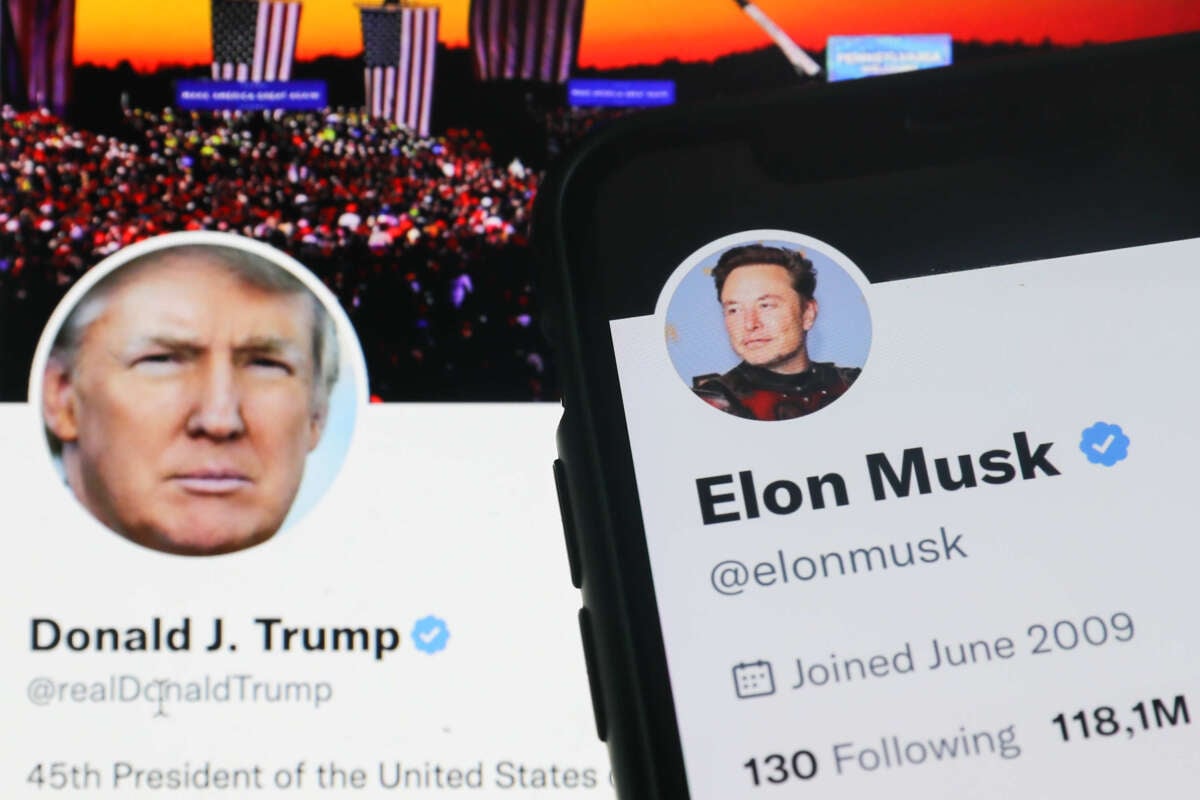 Former President Donald Trump's Twitter account is displayed on a laptop screen along with Elon Musk's account displayed on a phone screen in a photo taken on November 22, 2022.