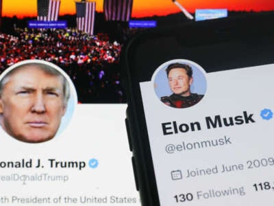 Former President Donald Trump's Twitter account is displayed on a laptop screen along with Elon Musk's account displayed on a phone screen in a photo taken on November 22, 2022.