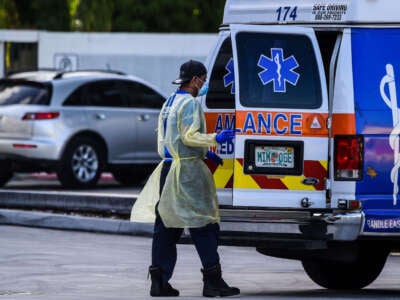 A medic prepares to transfer a patient on a stretcher from an ambulance outside of Emergency at Coral Gables Hospital where COVID patients are treated in Coral Gables near Miami, Florida, on July 30, 2020.