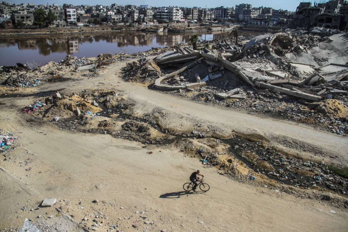 Sewage water and destroyed buildings are pictured in Gaza City, August 12, 2024.