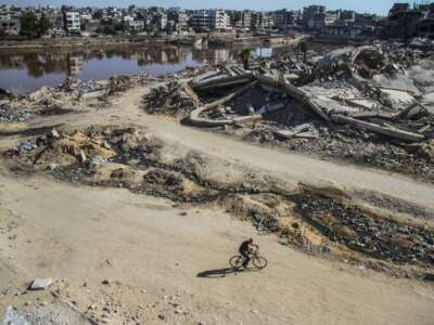 Sewage water and destroyed buildings are pictured in Gaza City, August 12, 2024.