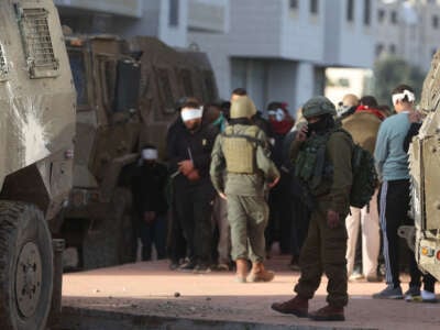 Israeli forces arrest several Palestinians during a raid on the Tulkarm refugee camp in the West Bank on January 18, 2024.