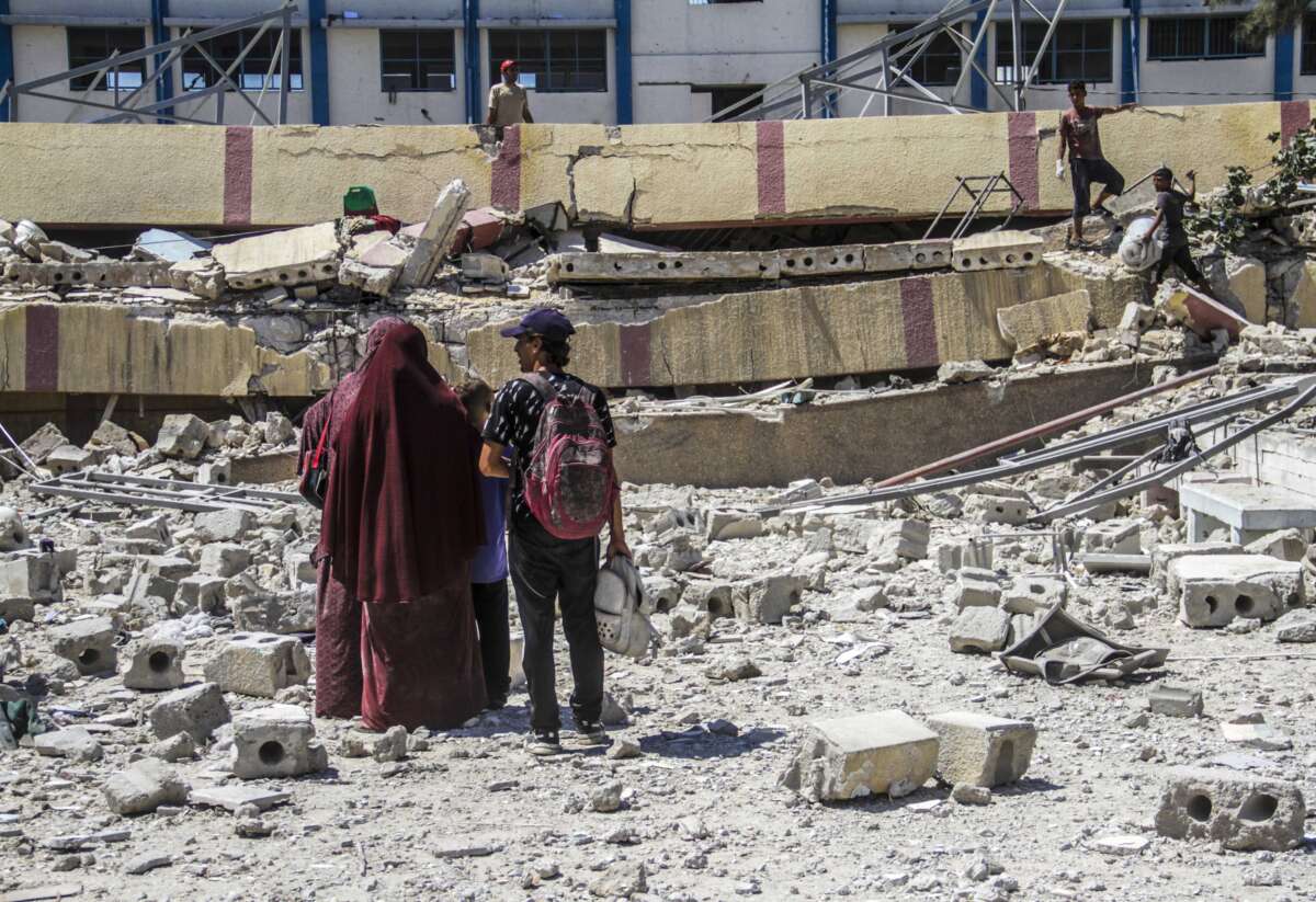 Palestinian civilians and civil defense teams conduct a search-and-rescue operation after an Israeli airstrike against the Mustafa Hafiz School where displaced Palestinians were sheltering in the Er-Rimal neighborhood of Gaza on August 20, 2024.