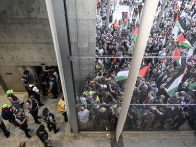 People hold a pro-Palestine protest outside the United Center in Chicago, Illinois, on August 21, 2024, the third day of the Democratic National Convention.