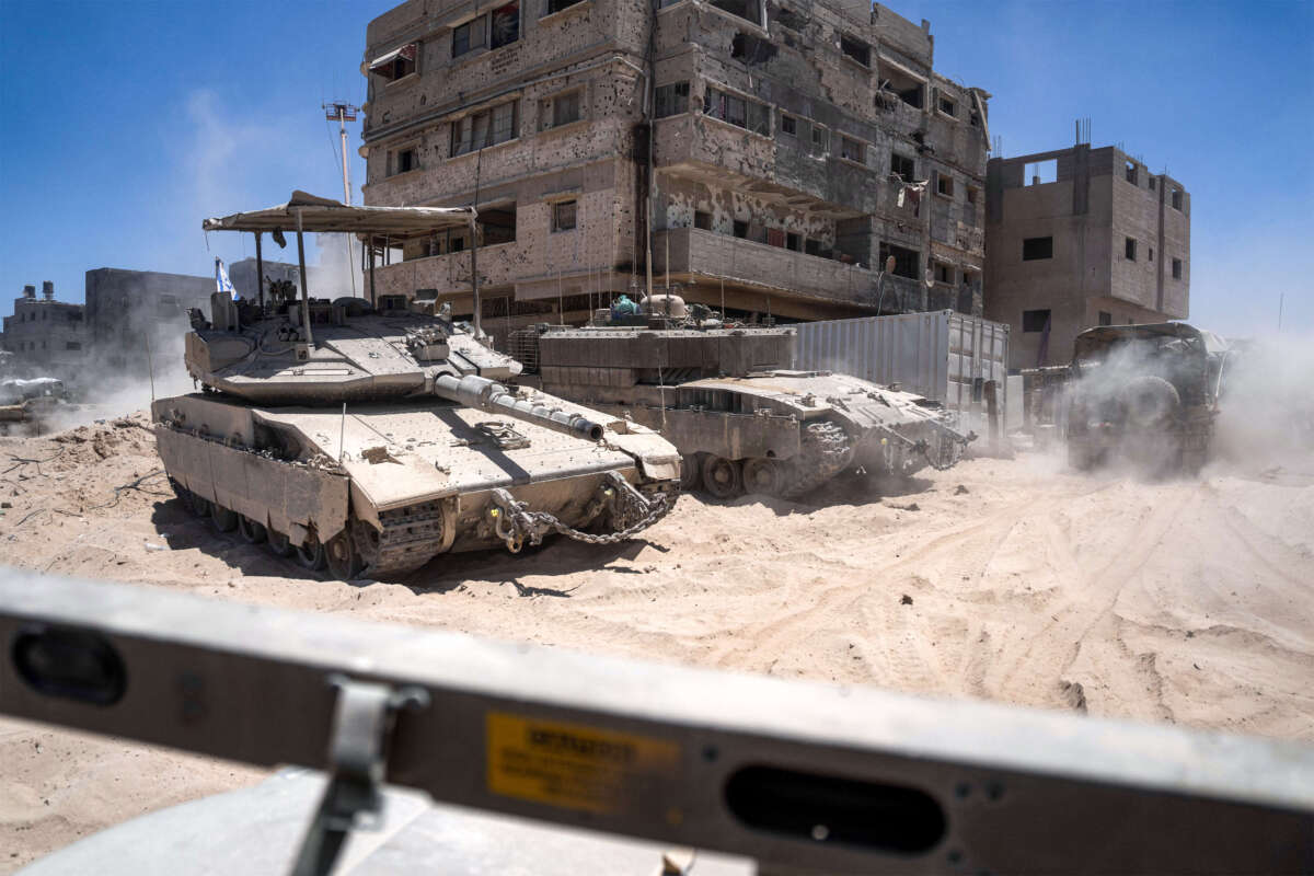 Israeli tanks are seen next to destroyed buildings during a ground operation in the southern Gaza Strip on July 3, 2024.